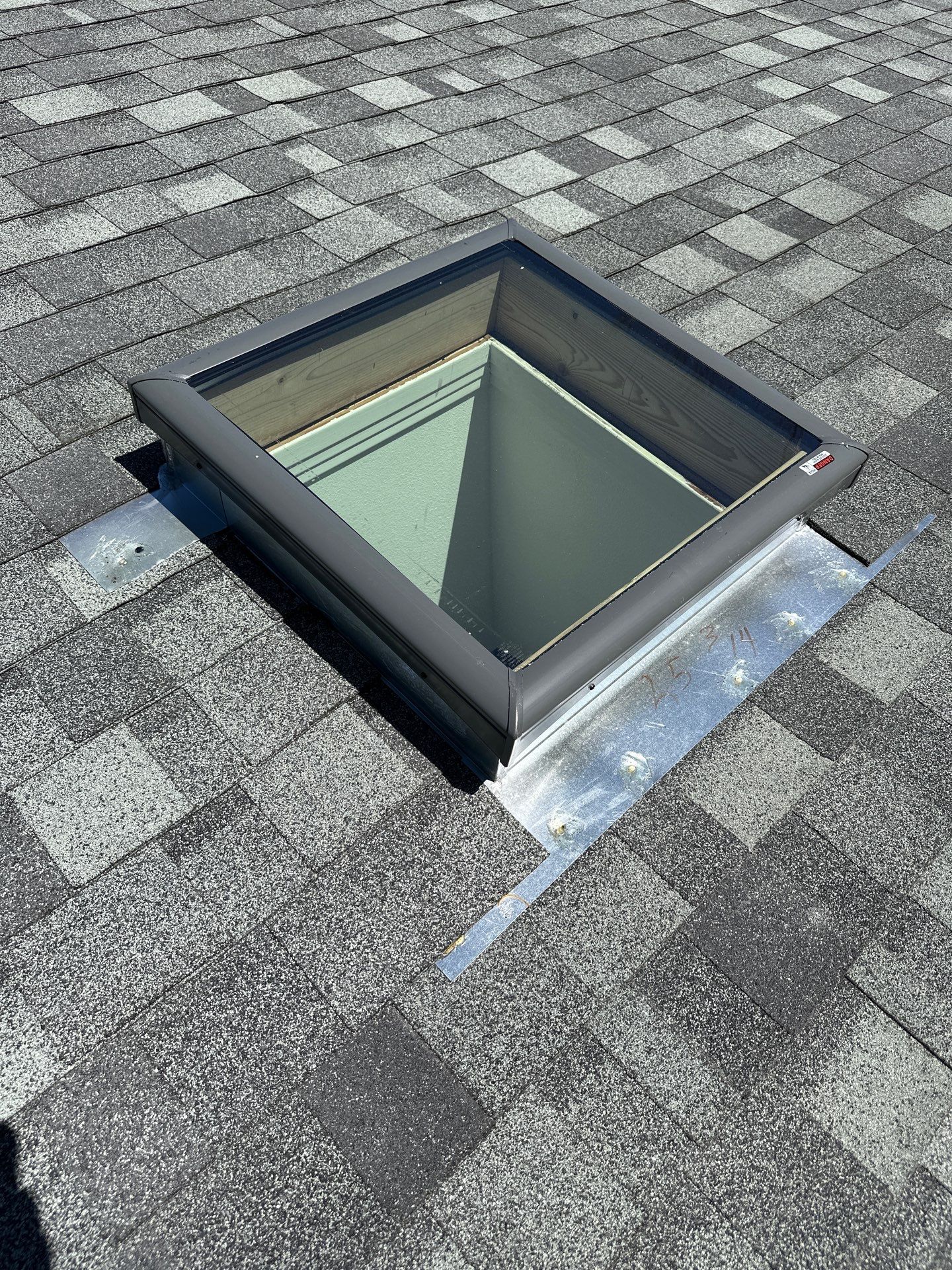 A skylight is sitting on top of a brick roof. - before