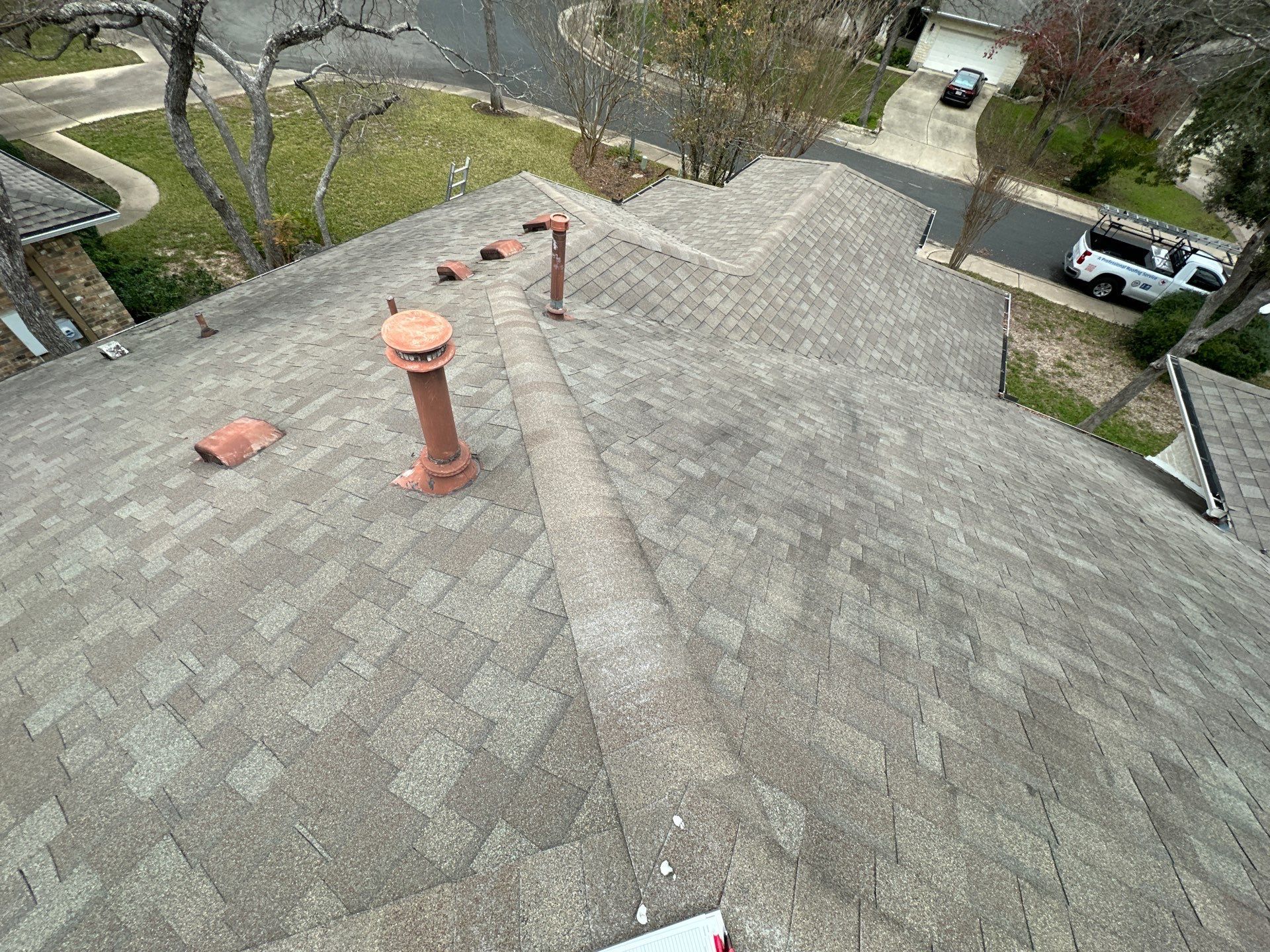 A person is standing on the roof of a house - after