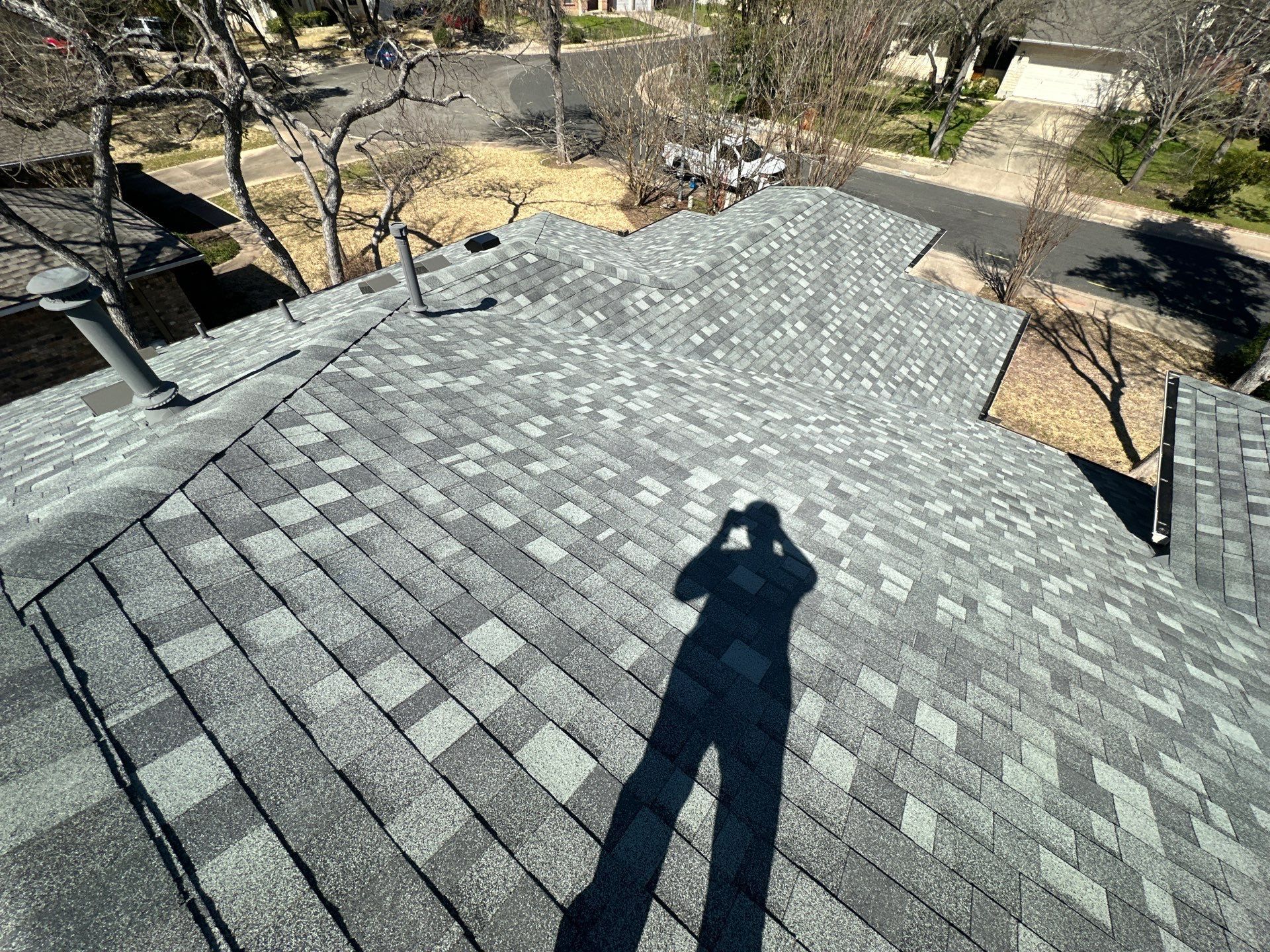 An aerial view of a roof with a chimney on it - before