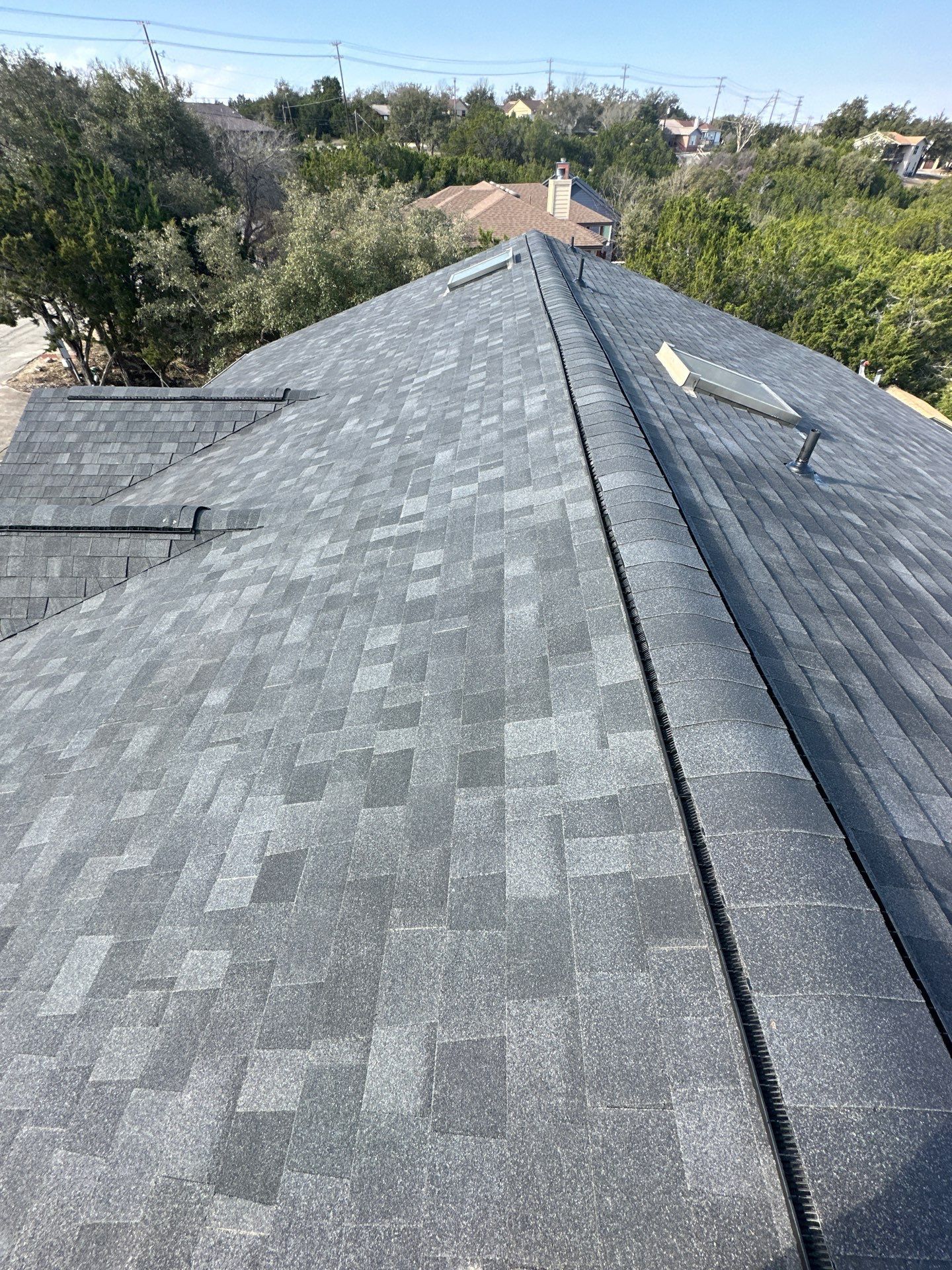 A close up of a roof with shingles on it - after