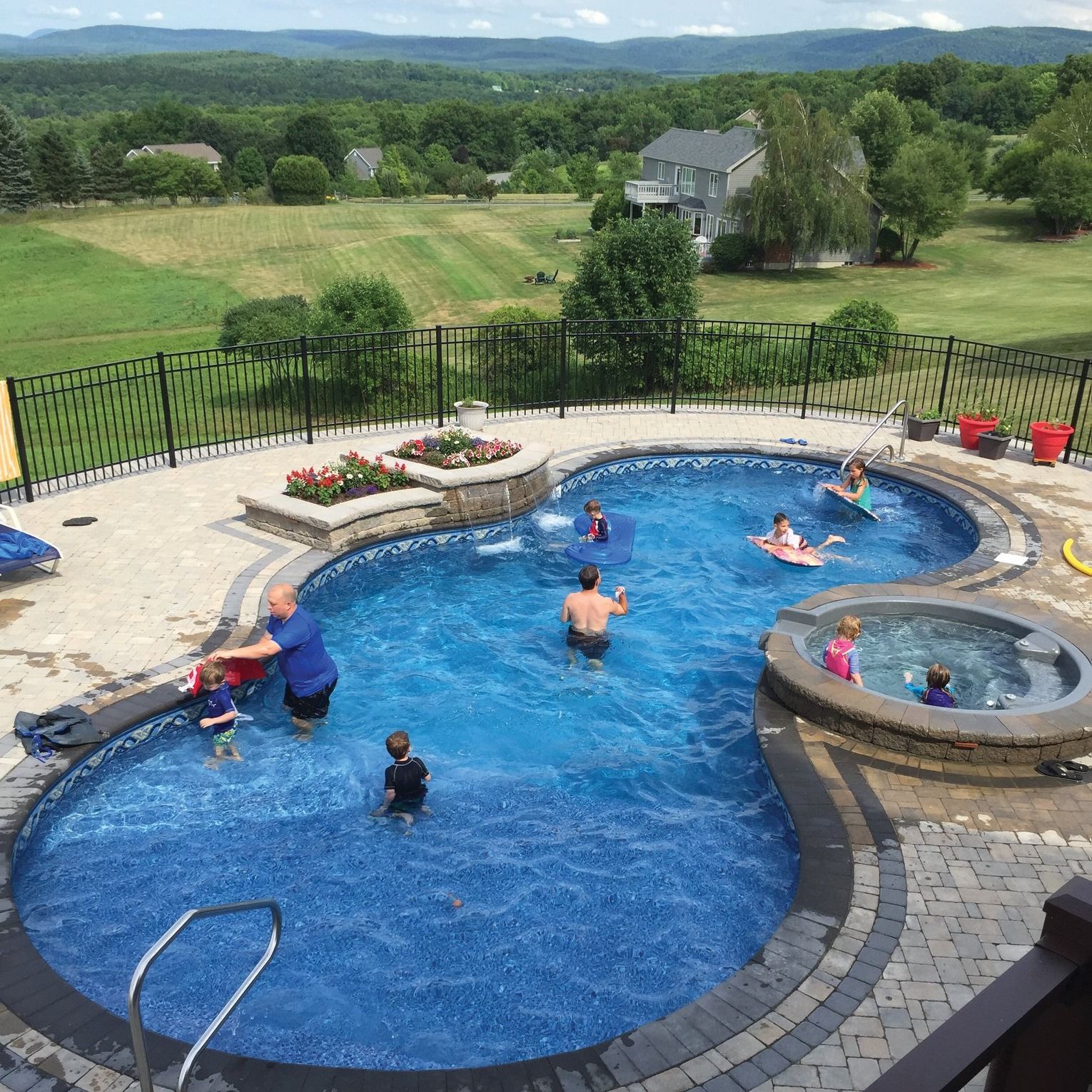 A group of people are playing in a large swimming pool