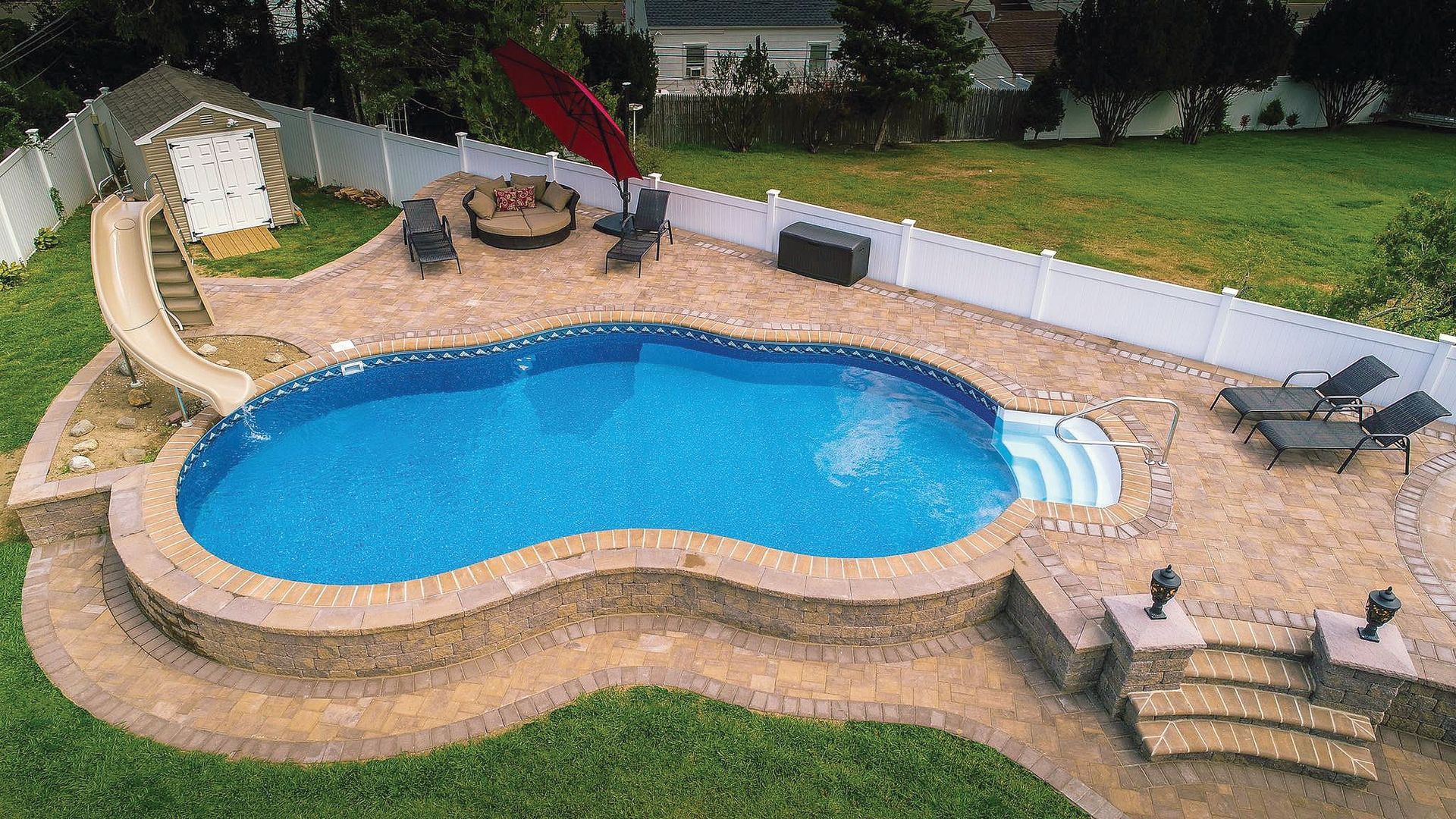 An aerial view of a swimming pool in a backyard