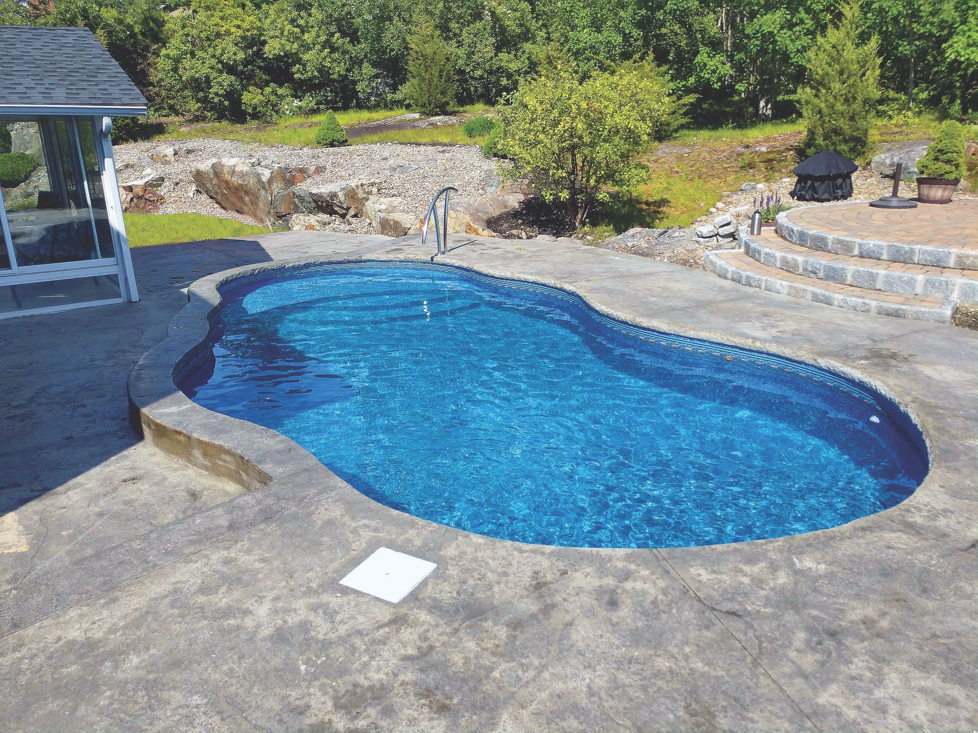 An aerial view of a large swimming pool in a backyard