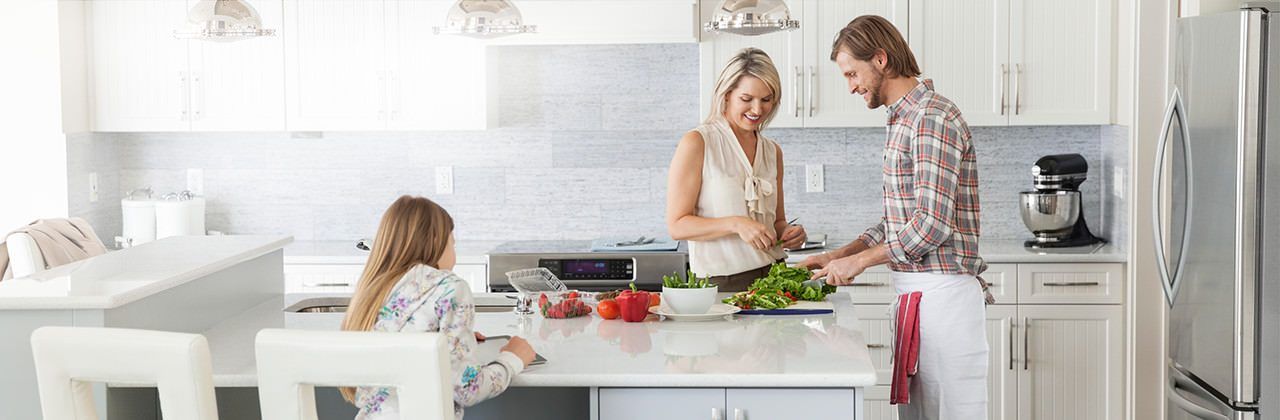 A family is cooking together in a kitchen.