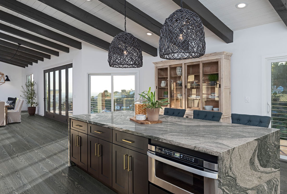 A kitchen with a large island and stainless steel appliances.