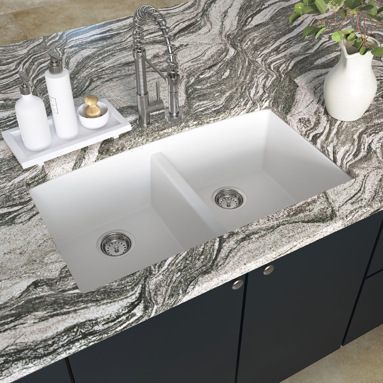 A kitchen sink sitting on top of a granite counter top