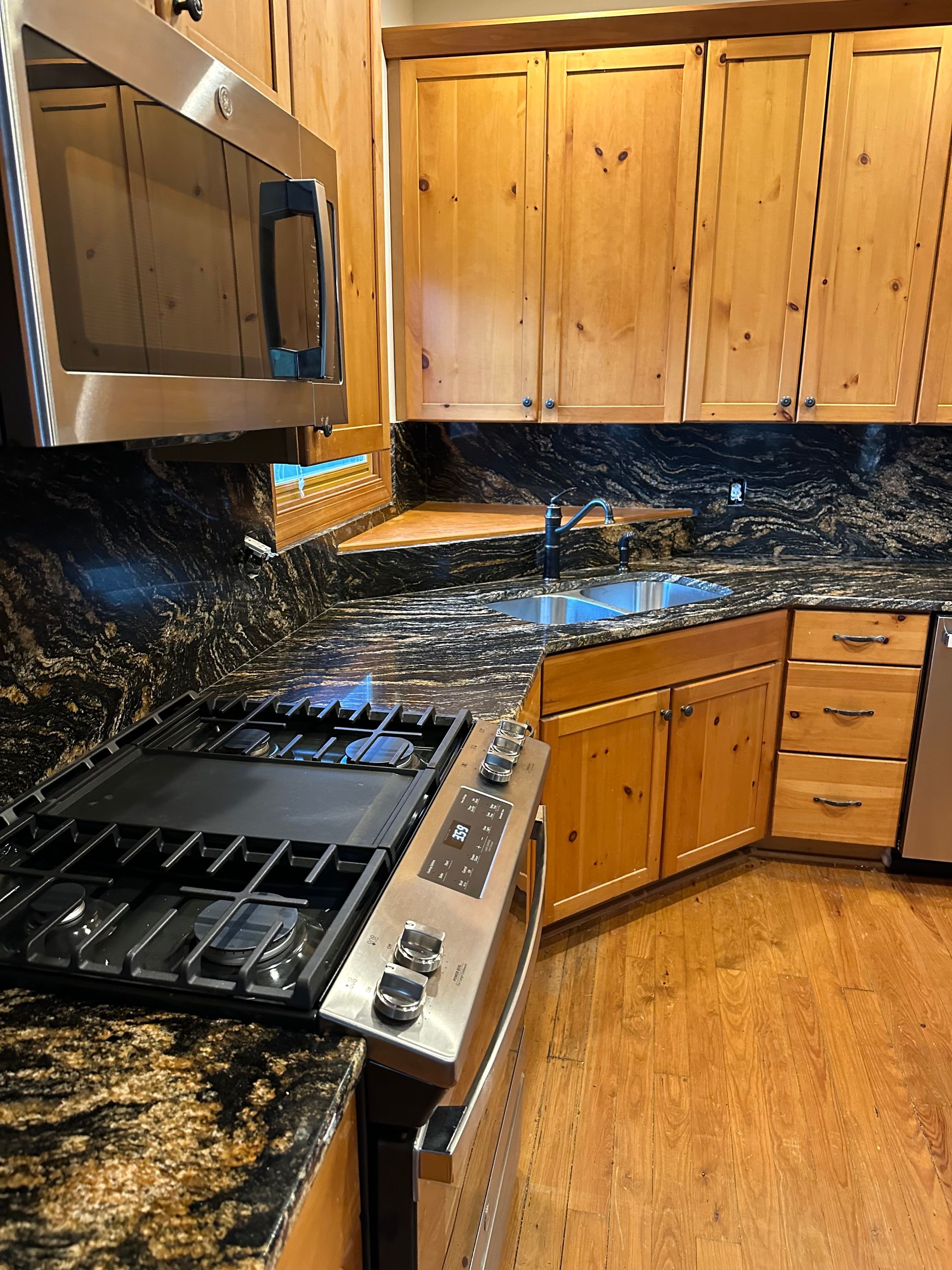 A kitchen with stainless steel appliances and granite counter tops