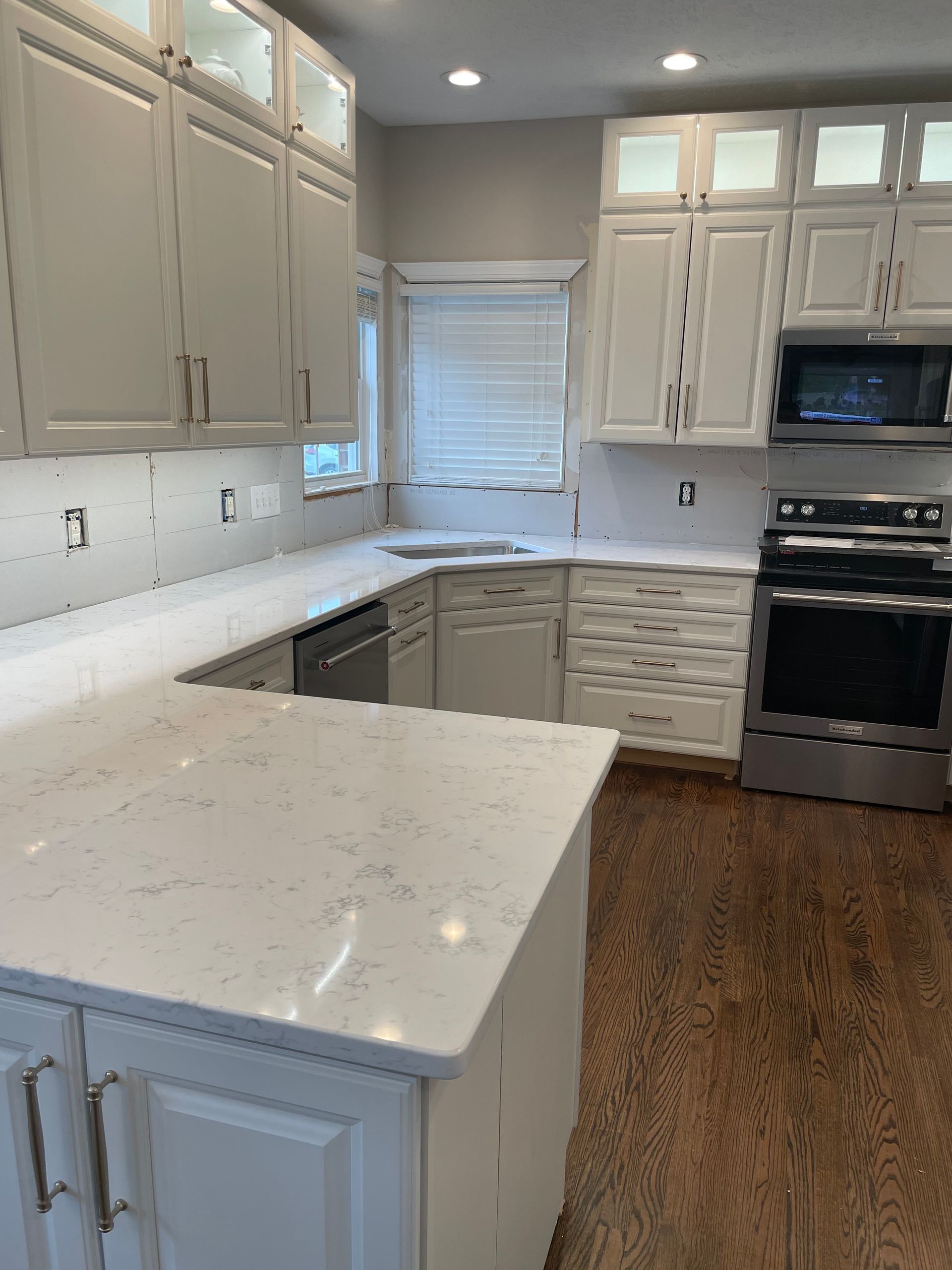 A kitchen with white cabinets and stainless steel appliances.