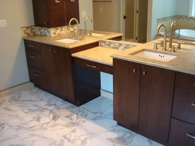 Dark wood double-sink bathroom vanity with beige countertops and marble-pattern tile flooring.