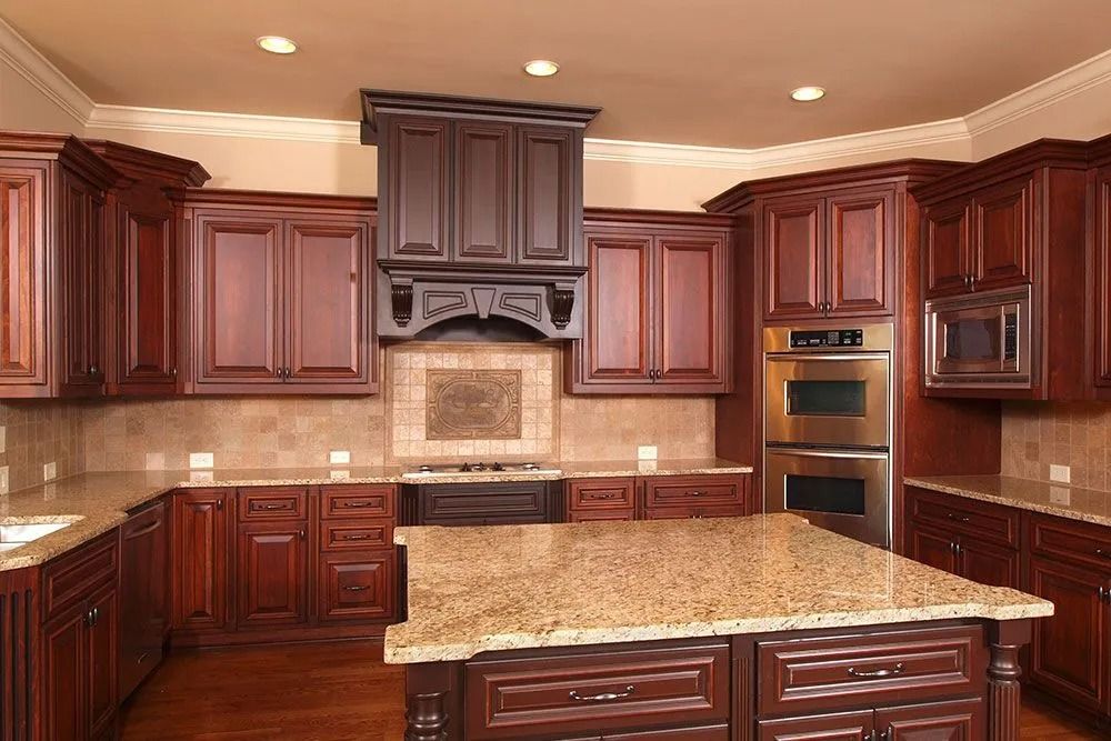 Spacious kitchen with dark wood cabinets, granite island, and stainless steel built-in oven