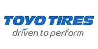 TOYO TIRES logo with blue text and gray “driven to perform” tagline on a white background