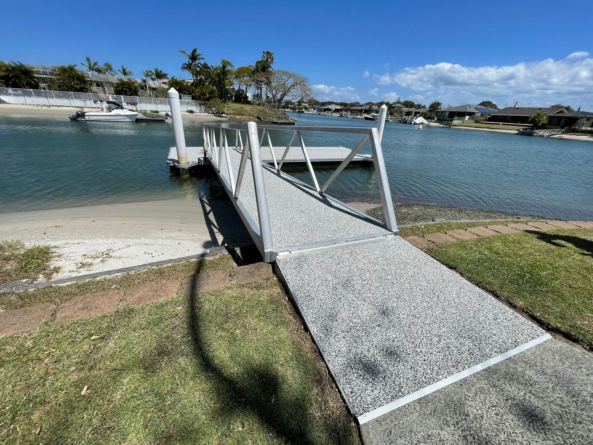 A dock with a ramp leading to a body of water.