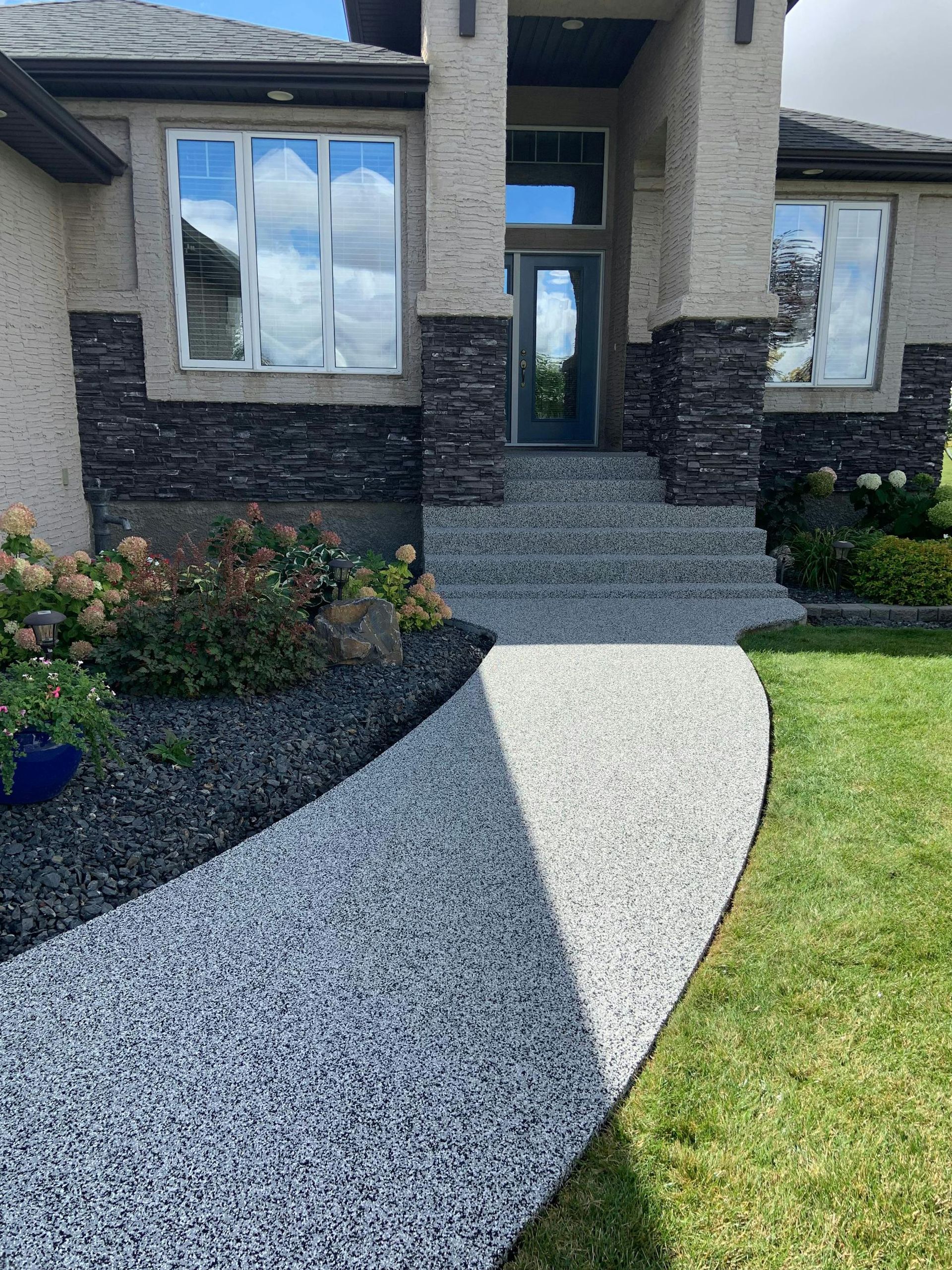 A walkway leading to the front door of a house.