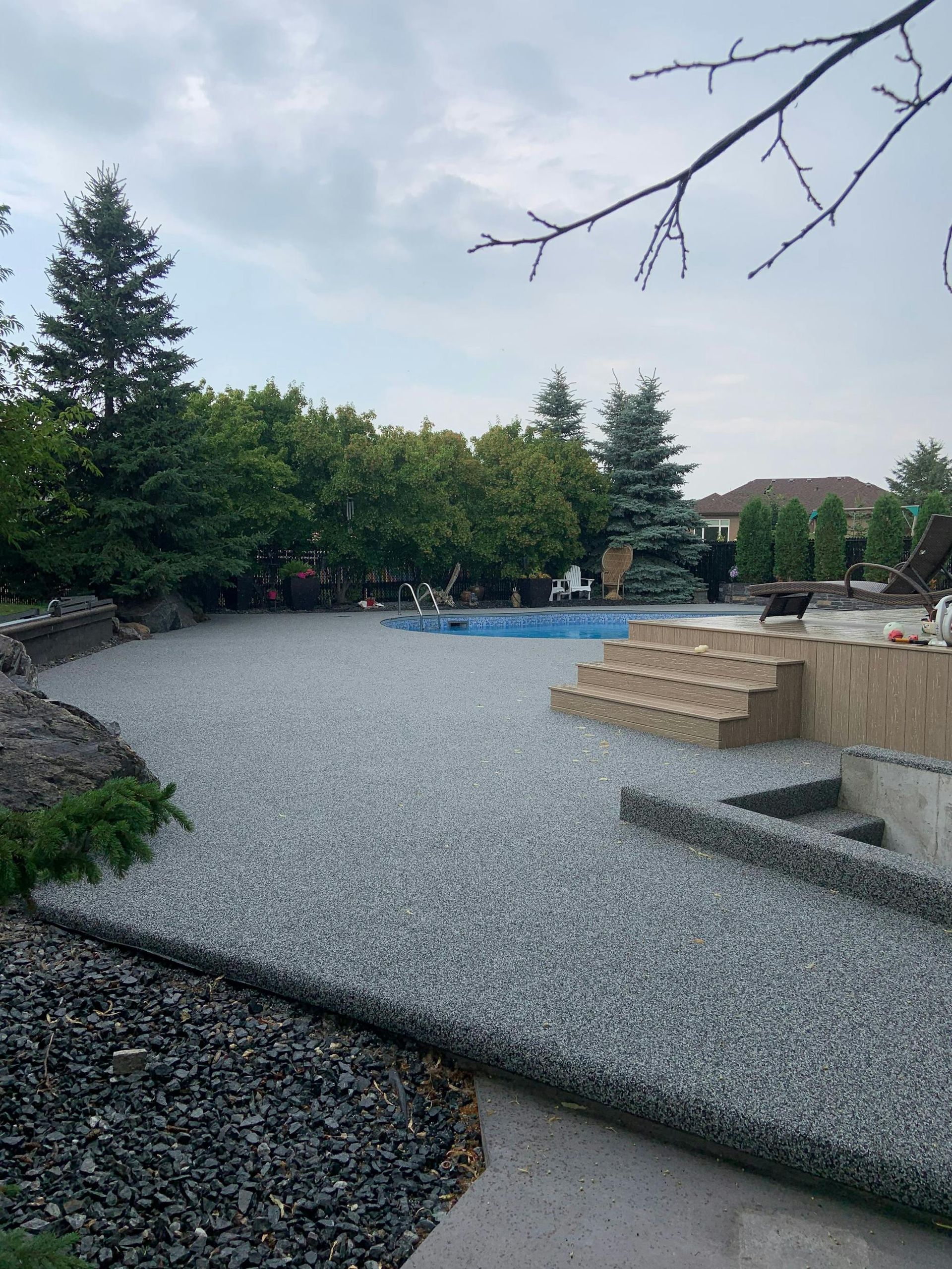 A patio with a swimming pool in the background.