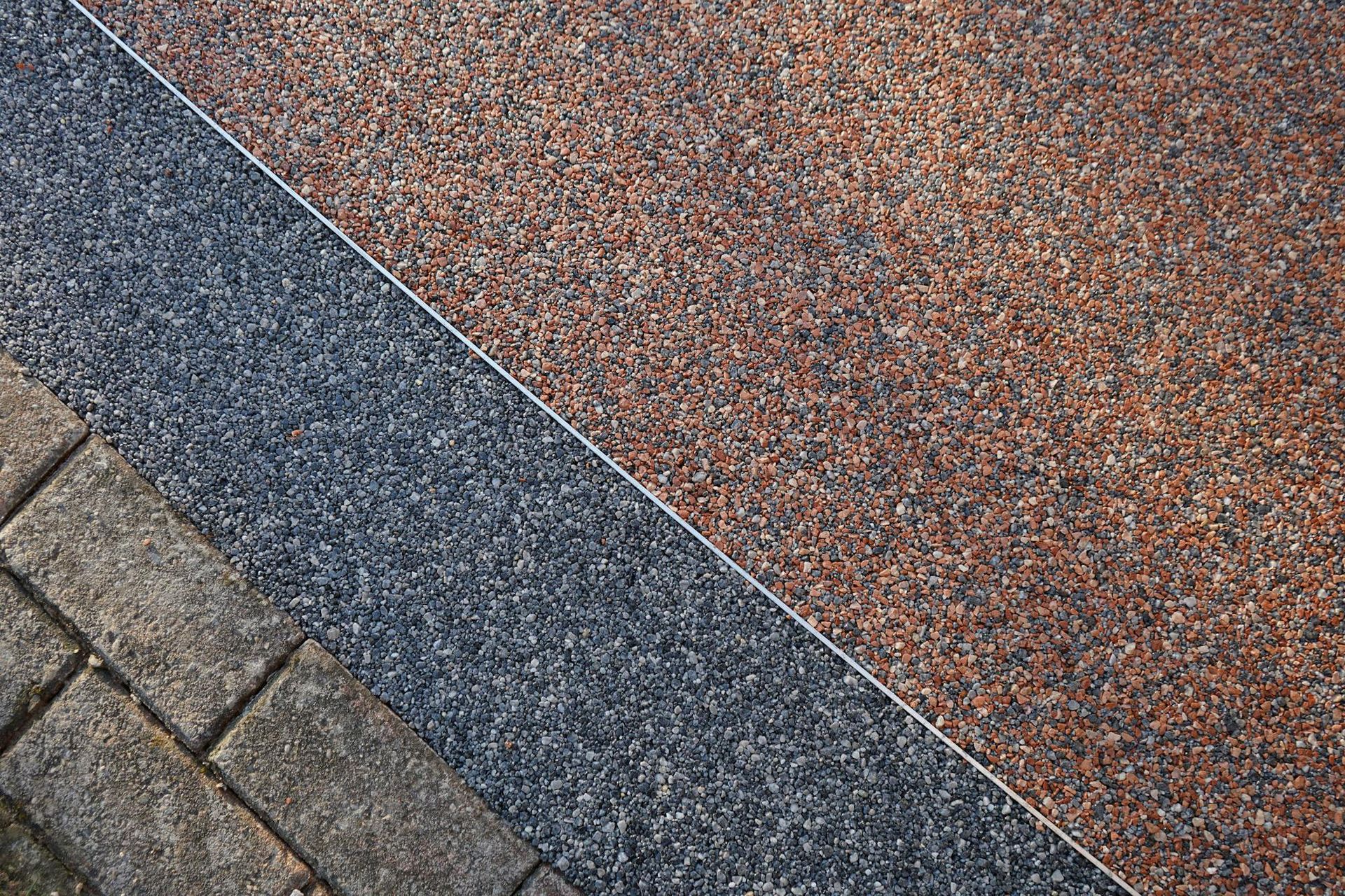A close up of a brick walkway with different types of stone.