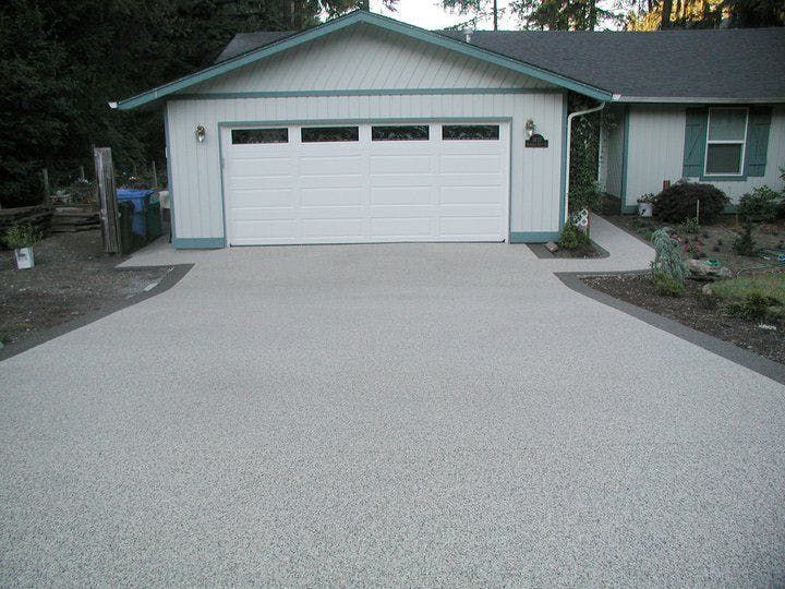 A white house with a white garage door.