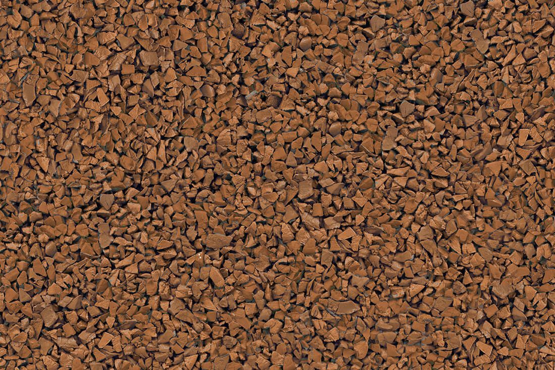 A close up of a pile of brown gravel.