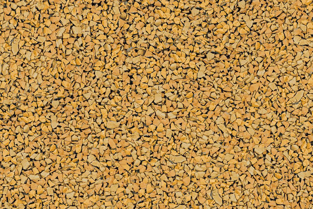 A close up of a pile of yellow gravel.
