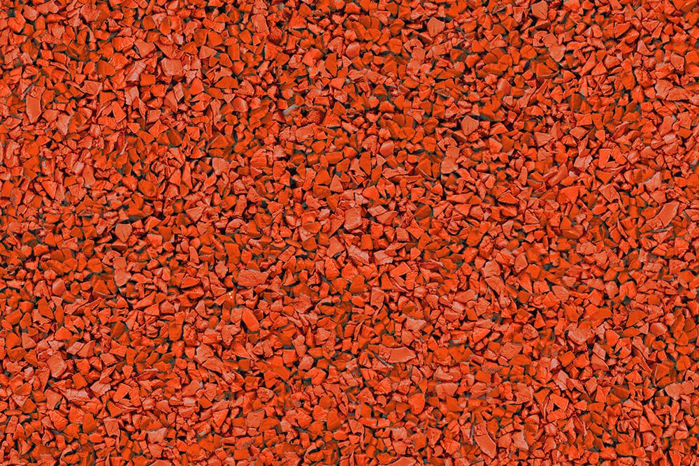 A close up of a pile of red gravel.