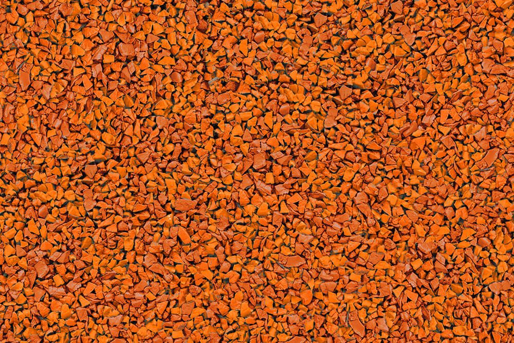 A close up of a pile of orange gravel.