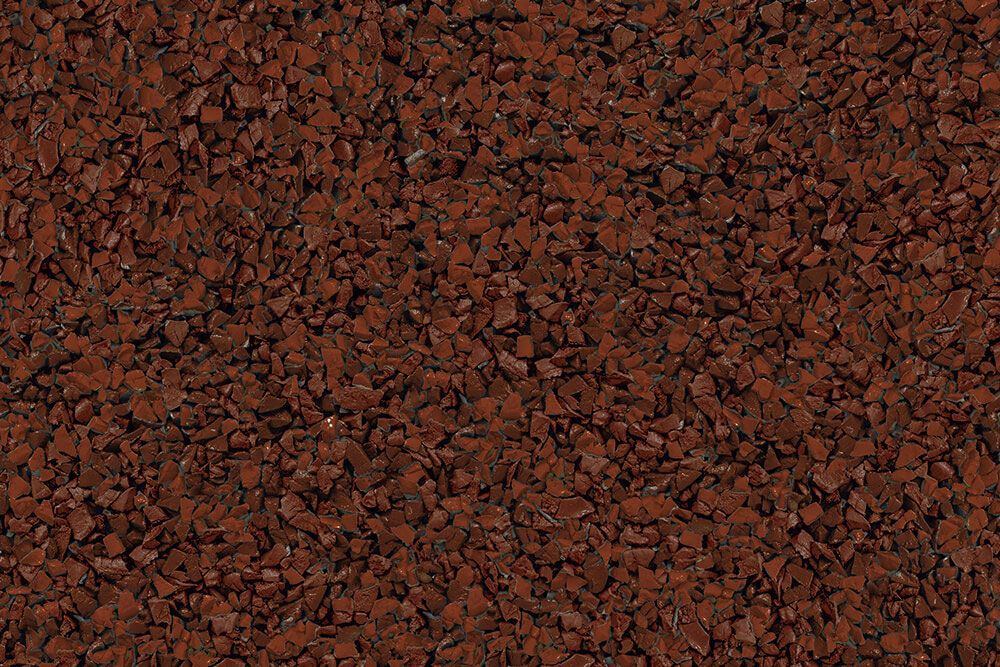 A close up of a pile of red gravel.