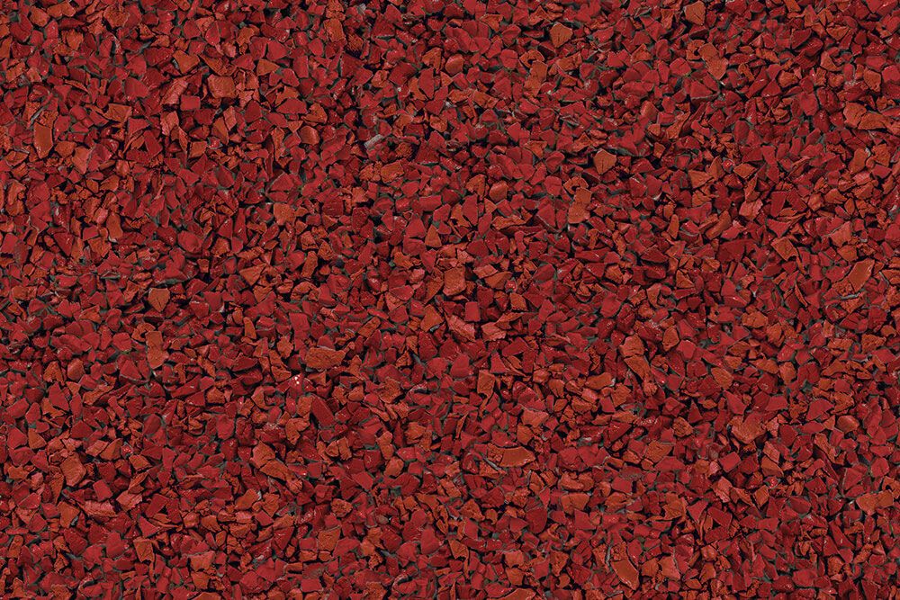 A close up of a pile of red gravel.