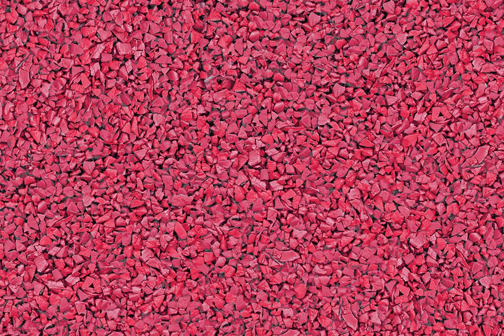 A close up of a pile of red gravel.