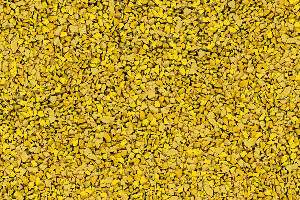 A close up of a pile of yellow gravel.