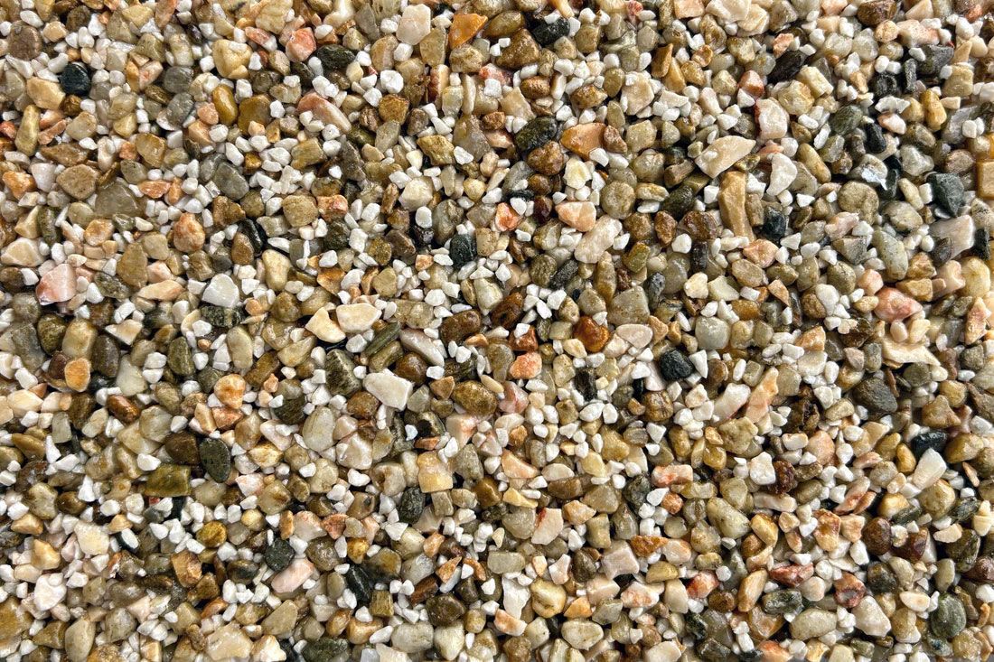 A close up of a pile of rocks on a beach.