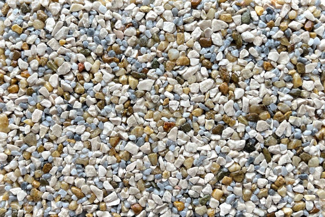 A pile of small rocks of different colors and sizes.