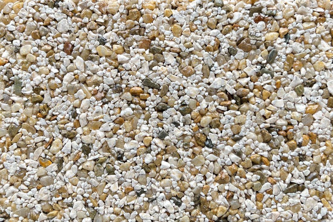 A close up of a pile of small rocks on a beach.