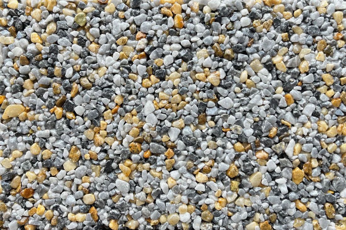 A close up of a pile of gravel with gray and yellow stones.