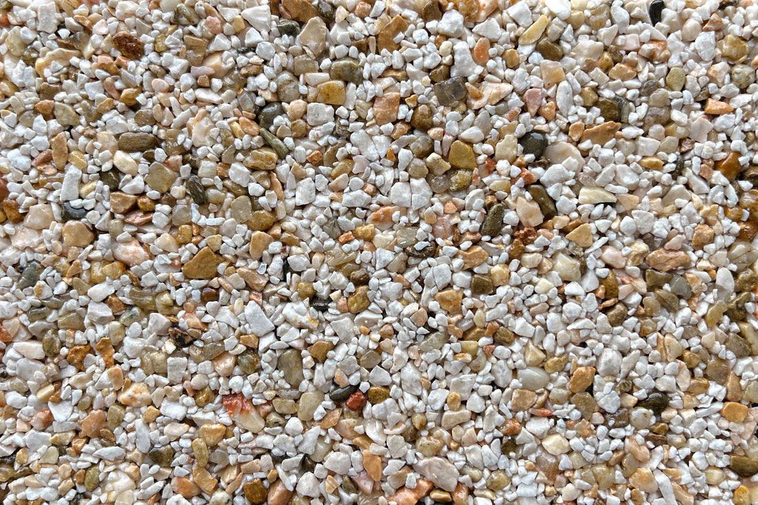 A pile of small rocks on a white surface.