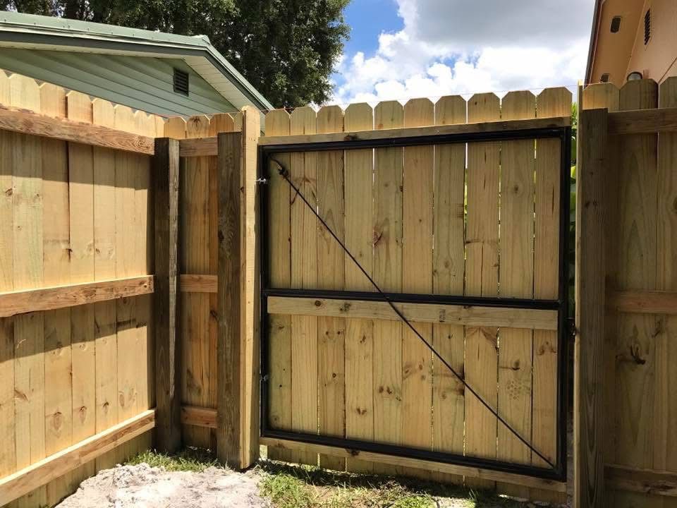 A wooden fence with a gate attached to it.