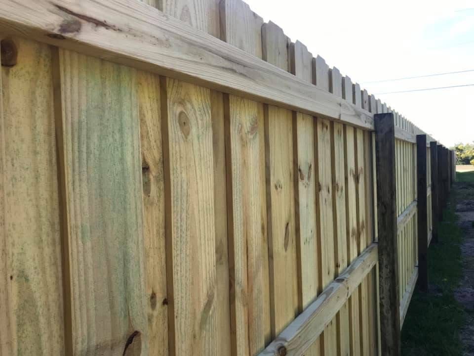 A close up of a wooden fence on a sunny day.