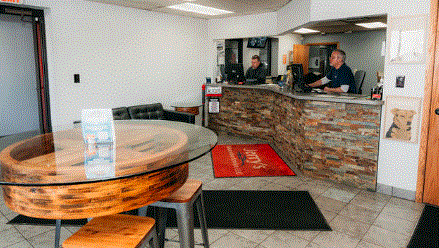 Car repair shop interior with a reception desk and waiting area.