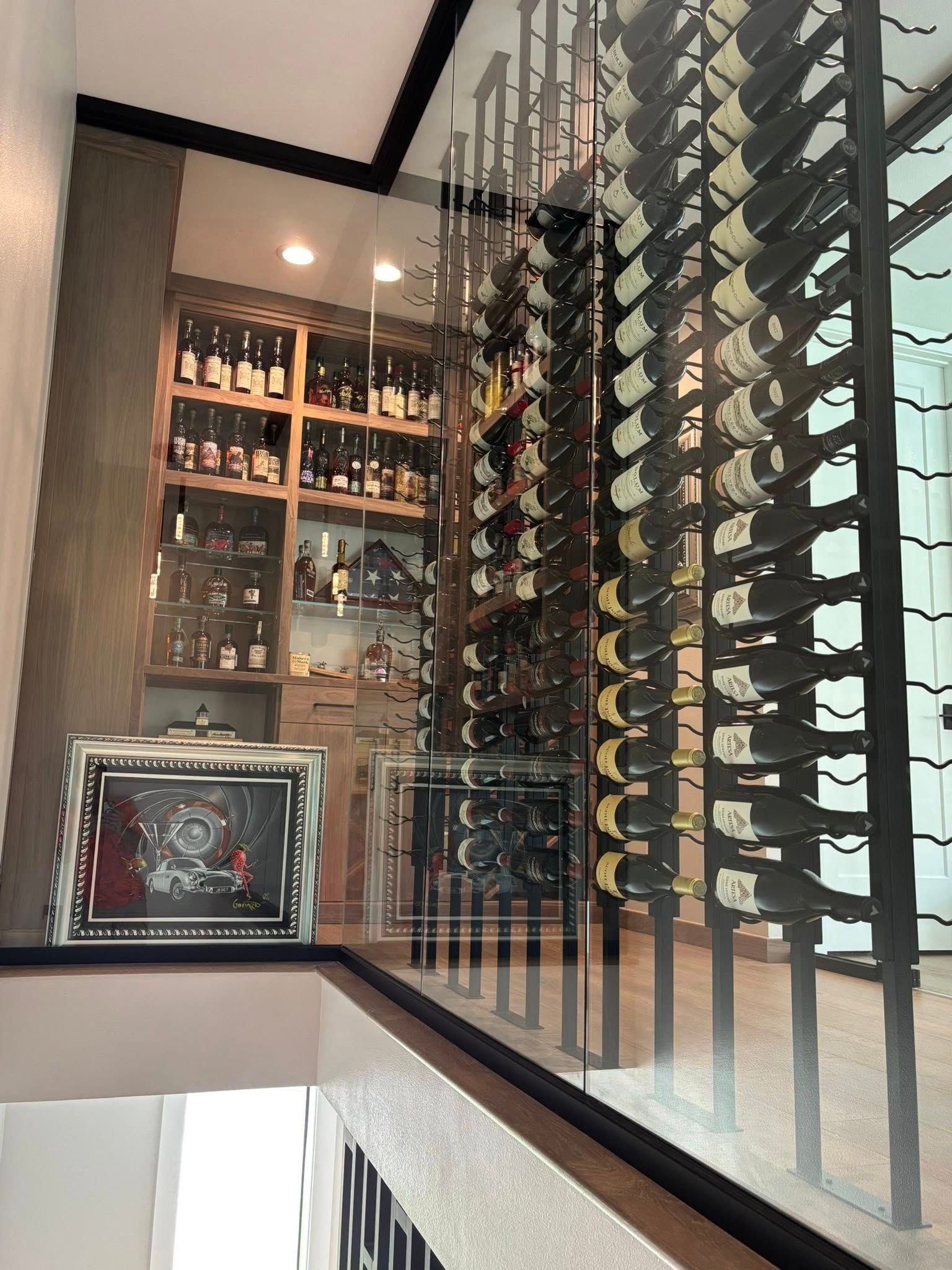 Interior of a wine cellar with rows of bottles and shelves under warm lighting
