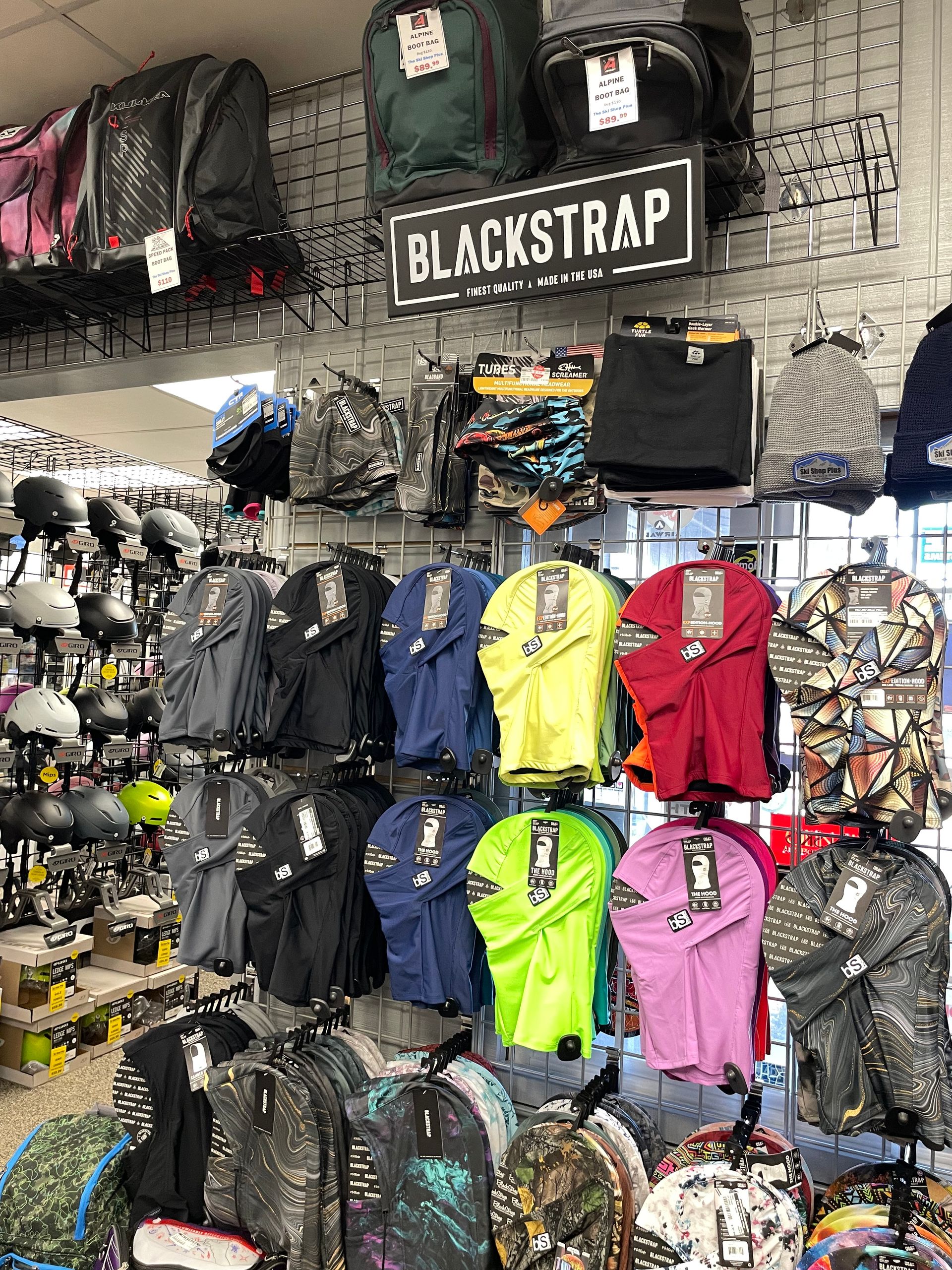 A store filled with lots of clothes and backpacks.