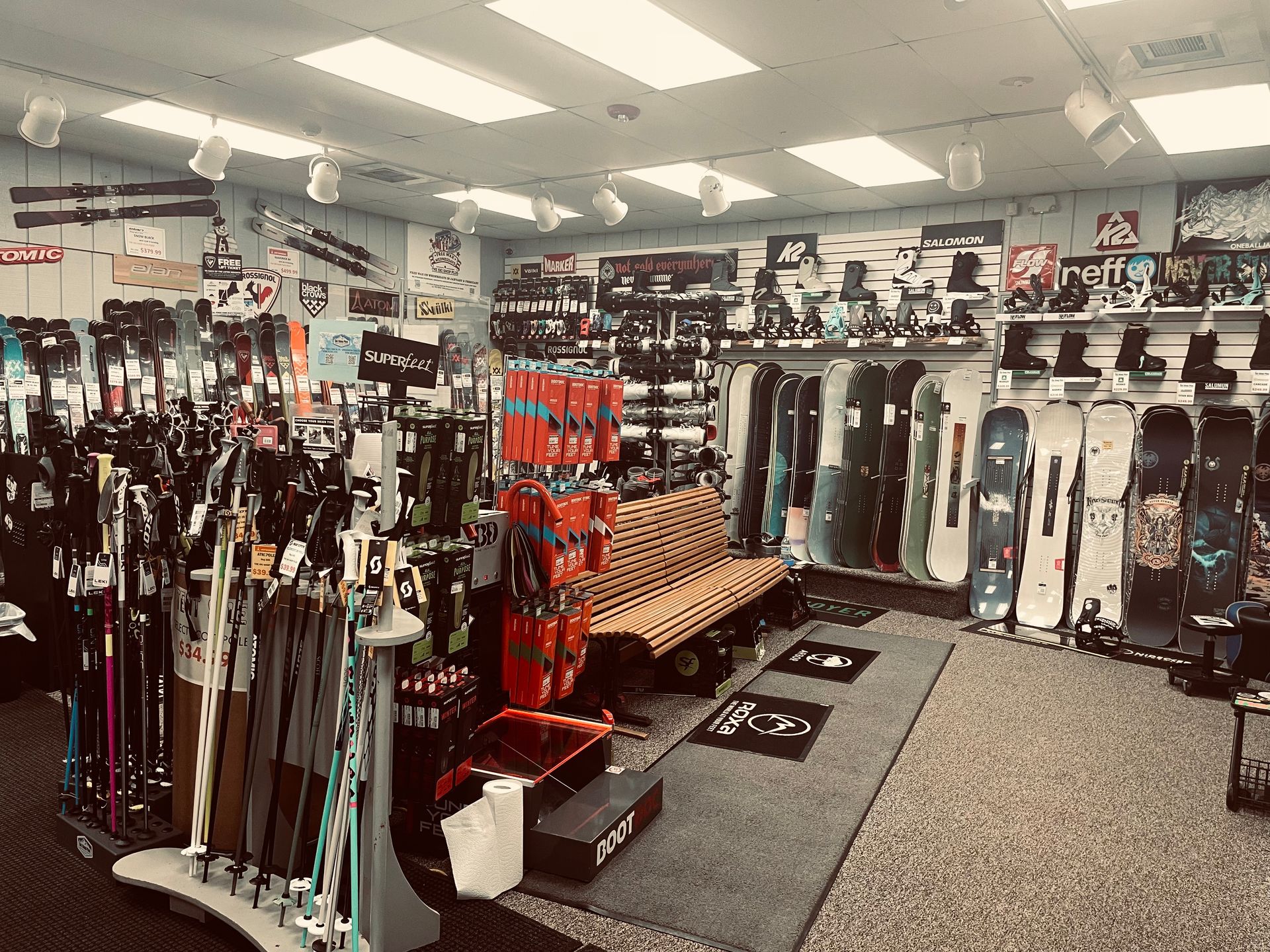 A large room filled with lots of skis and snowboards.