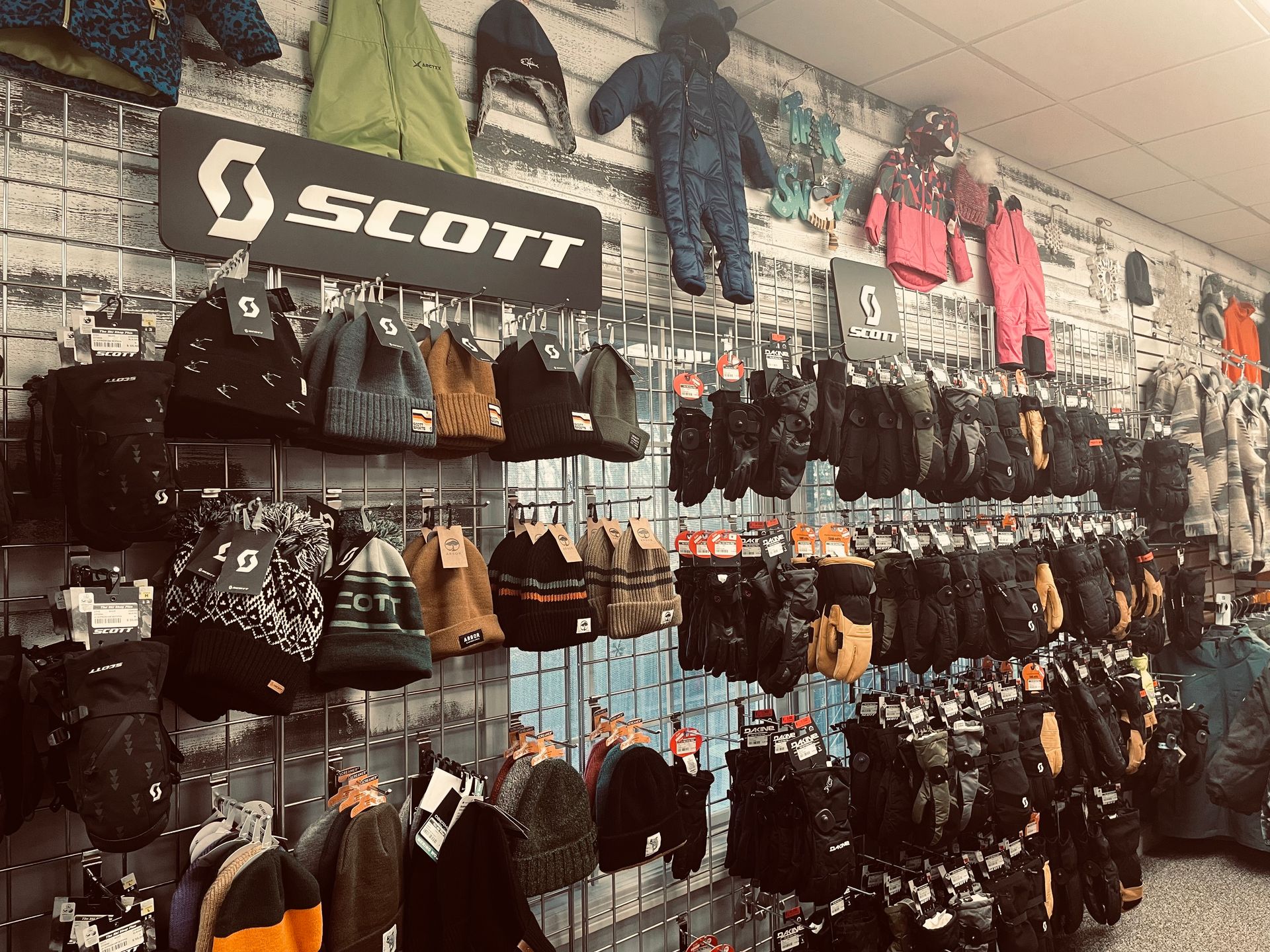 A store filled with lots of hats , gloves , and jackets.