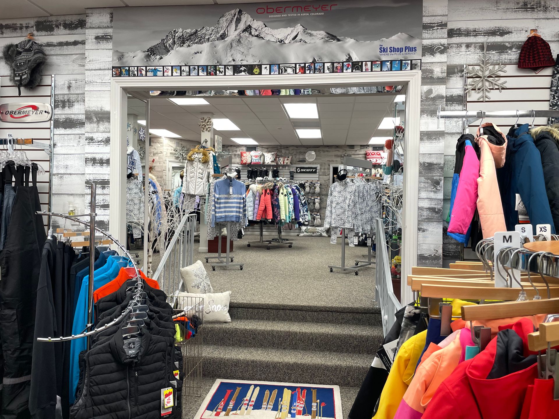 A store filled with lots of clothes hanging on racks.