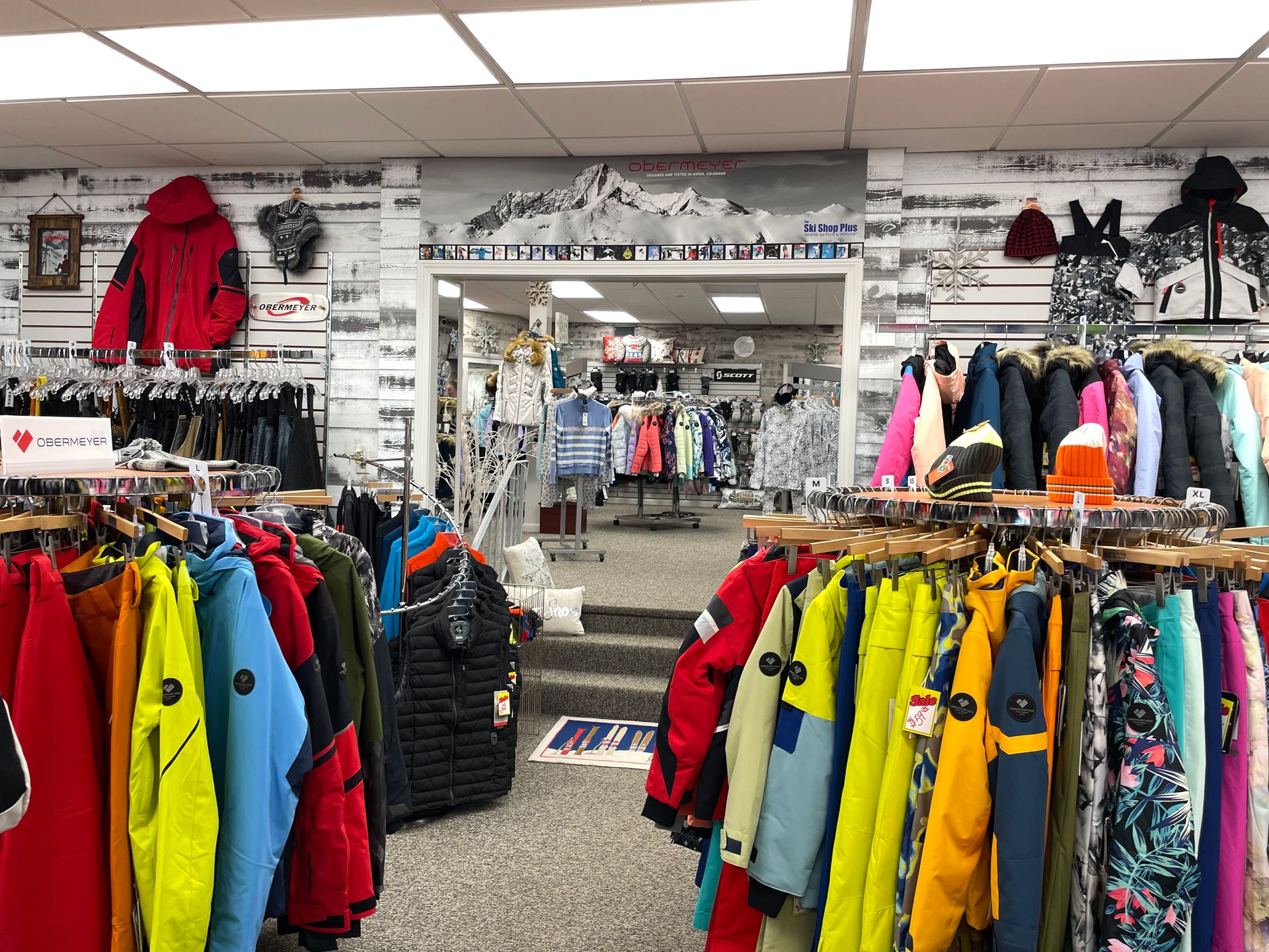 A store filled with lots of clothes hanging on racks.