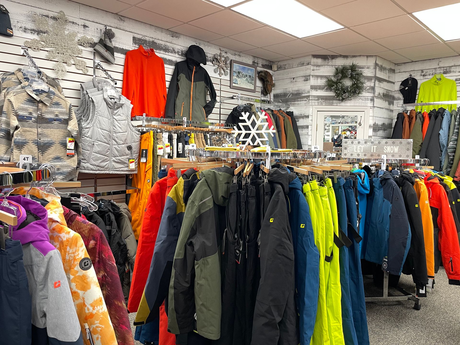 A store filled with lots of jackets hanging on racks.
