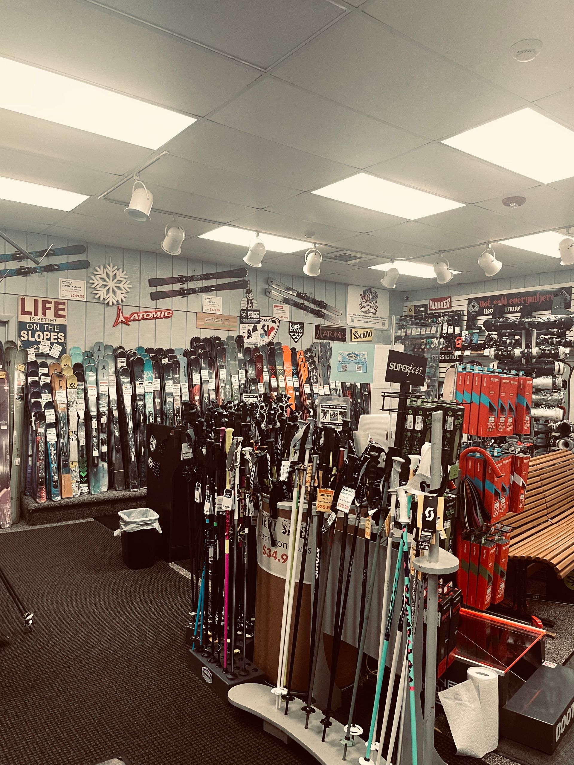 A large room filled with lots of skis and poles.