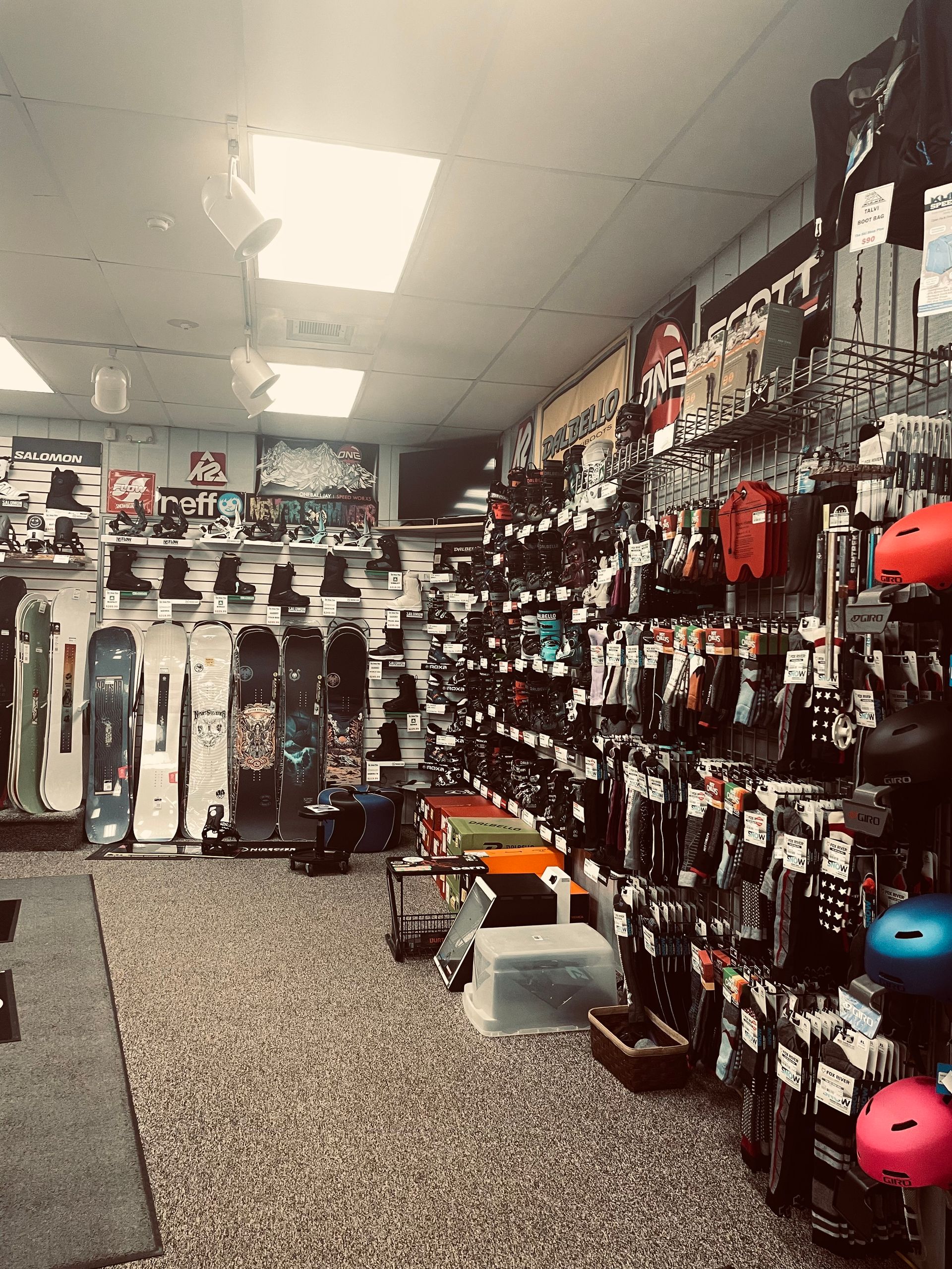 A store filled with lots of snowboards and helmets.