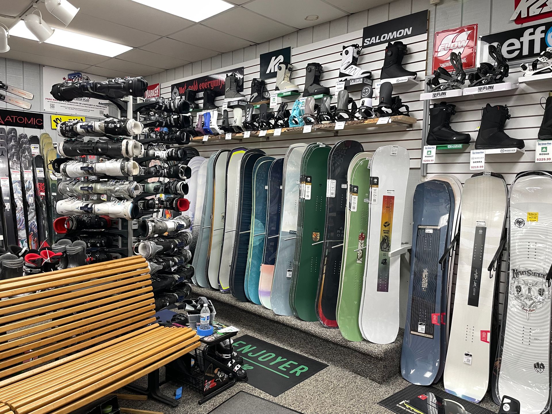 A store filled with lots of snowboards and skis.