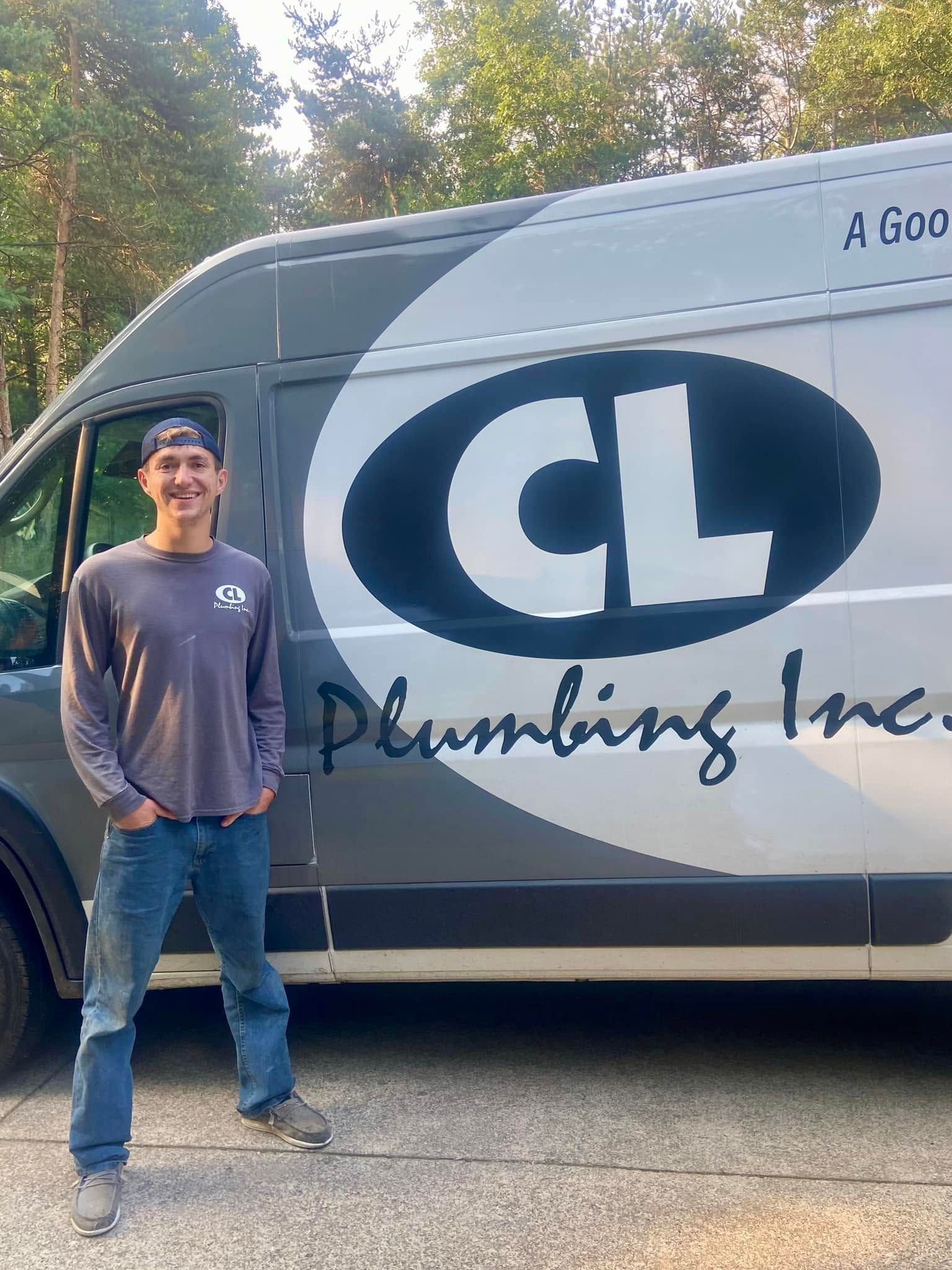 Man standing beside a CL Plumbing Inc. van outdoors, smiling