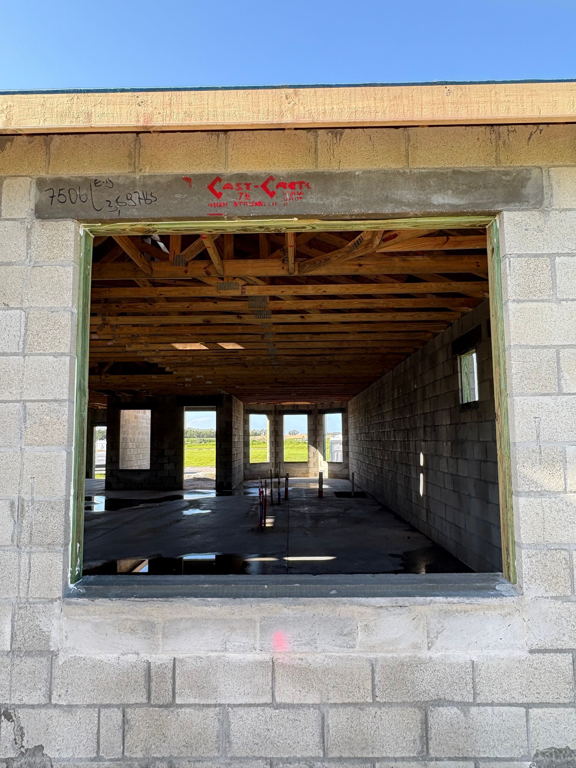 Concrete block walls, wood framing and beams visible.