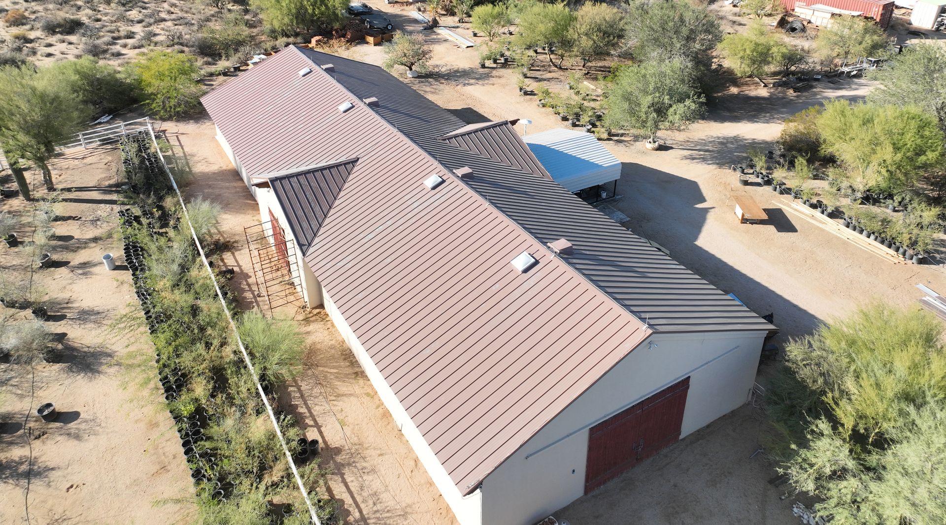 An aerial view of a house with a brown metal roof.