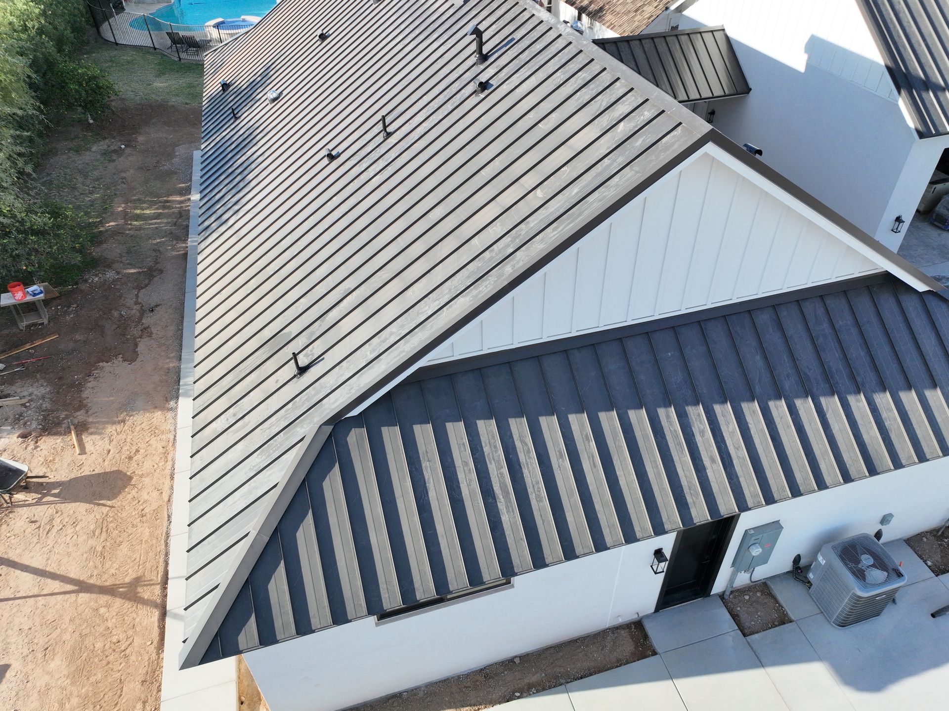 An aerial view of a house with a metal roof.
